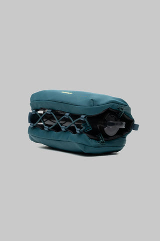 Topologie medium bottle sacoche, deep teal side view with webbing strap and pocket