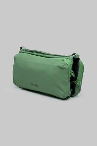 Topologie medium bottle sling bag, ivy green with side pocket and carrying strap