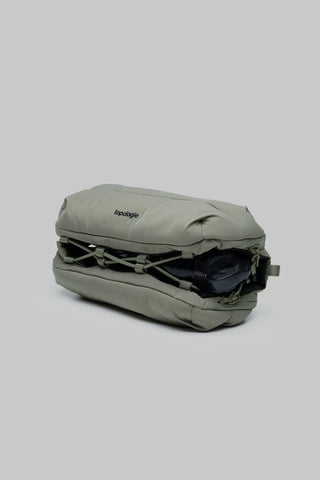 Topologie medium bottle sacoche in moss green, side view with flap and straps