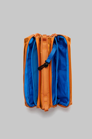 Orange and blue lined bottle sacoche, open top with elastic pockets and orange straps