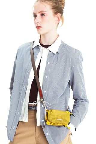 Mustard yellow ripstop mini bottle pouch with drawstring closure and clip-on strap.