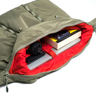 Hobo bag open with zipper, showing red fabric lining and card slots inside