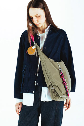 Medium hobo bag worn crossbody with olive fabric and adjustable strap; front D-ring