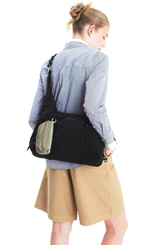 O-ring carabiner attached to a crossbody bag strap on a model
