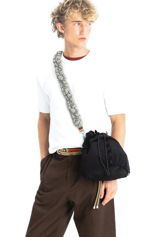 Moss green braided cloud strap worn crossbody with metal clip connectors