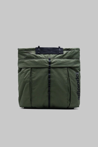 Nylon helmet bag in deep green with dark trim, padded flap, and front strap