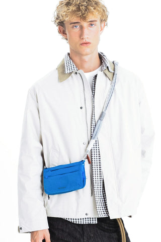 Topologie macrame strap in blue, worn crossbody with small pouch