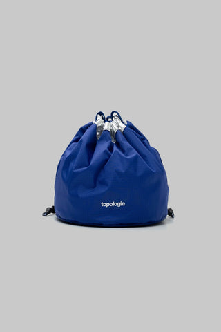 Reversible bucket bag in royal blue with gathered top and drawstring