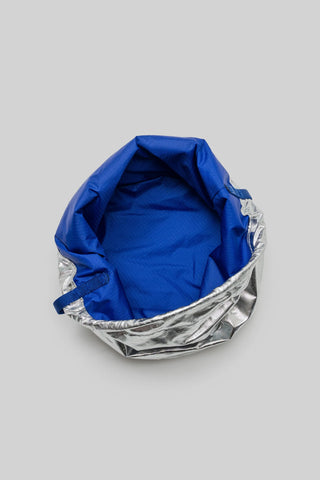 Reversible bucket bag interior in royal blue with metallic silver lining trim