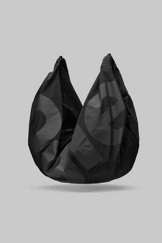Black crescent hobo bag with twin handles and circular pattern on gathered fabric