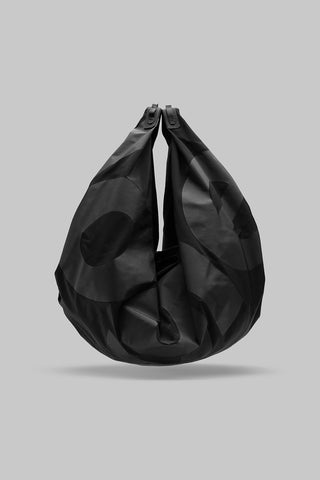 Black crescent hobo bag with dual top handles and subtle circular print