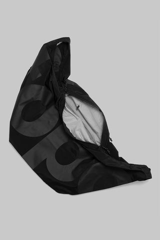 Black hobo bag with zip opening and circular pattern; interior pocket visible