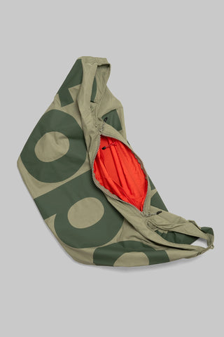 Topologie Robo bag flat lay, moss green nylon with beige circle print and orange lining