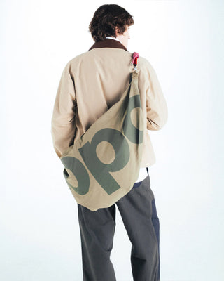 Topologie Robo bag on model back, beige-and-moss circle pattern and red zipper pull