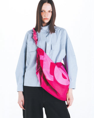 Topologie Robo bag, bright pink translucent tote worn crossbody with open top