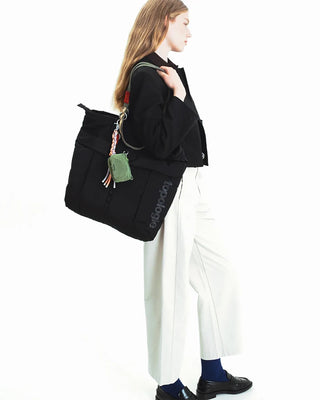 Topologie Sinnet keychain with braided cord, green charm and metal clip on black bag