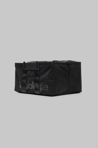 Medium black duffle bag with top handle and subtle logo print