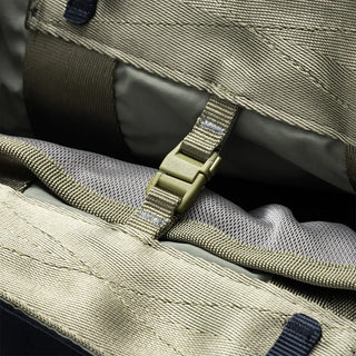 Small tote bag close-up of interior pocket with gray lining and olive webbing strap
