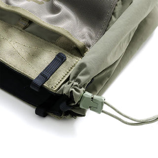 Small tote bag close-up: olive webbing strap, gray mesh pocket, and cord fastener