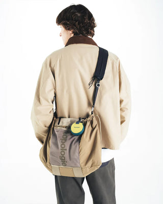 Small crossbody tote bag in olive green with adjustable strap and vertical front logo