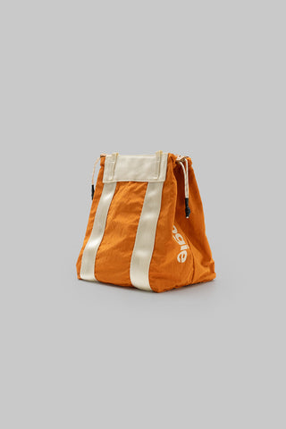 Small tote bag in burn orange with two white stripes and drawstring handles.