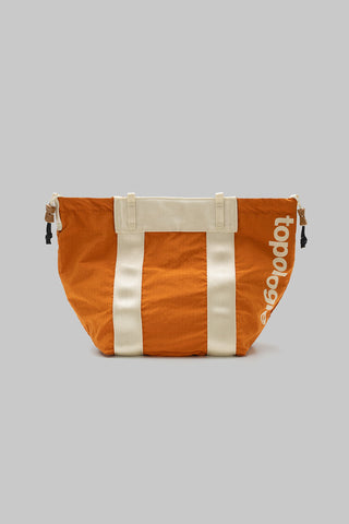 Small tote bag in burn orange with white vertical stripes and Topologie logo side.
