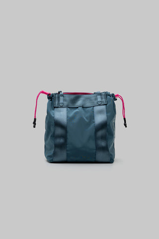 Small teal tote bag with drawstring cords and front pocket straps