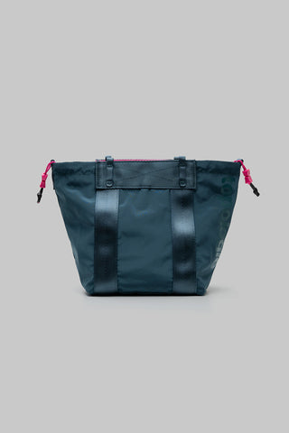 Small teal tote bag with drawstring cords and panel detailing, front view