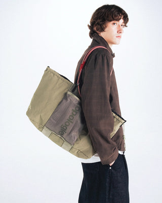 Canvas tote bag in olive with structured sides, top handles, and shoulder carry.