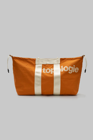 Orange tote bag with white vertical stripe center, drawstring top, and side tie tabs.