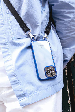Black strap with metal hooks and phone in blue case inside sling pouch
