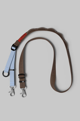 Utility sling with adjustable brown strap and metal clip hardware