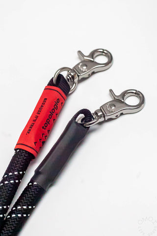 Black rope strap with two metal spring clips and Topologie red label