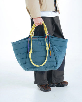 Neon lime braided O-rope strap on a quilted blue tote-style crossbody bag