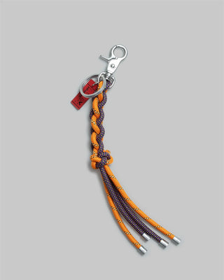 Topologie Sinnet keychain with orange braided cords and metal clip, arcade charm