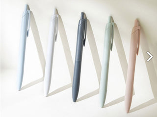 Five Jetstream Lite Touch ballpoint pens displayed: light blue, white, off black, sage, coral
