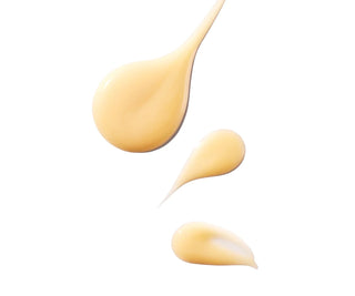 Spoonful and droplets of yellow serum