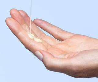 Hands with a small amount of yellow serum on palm