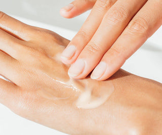 Skincare gel being smoothed onto hands, glossy clear moisturizer texture