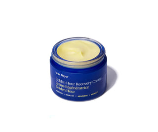 Open recovery cream jar showing pale yellow cream inside, blue container.