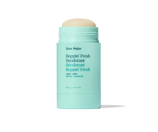 Capped mint teal deodorant stick with front label visible.