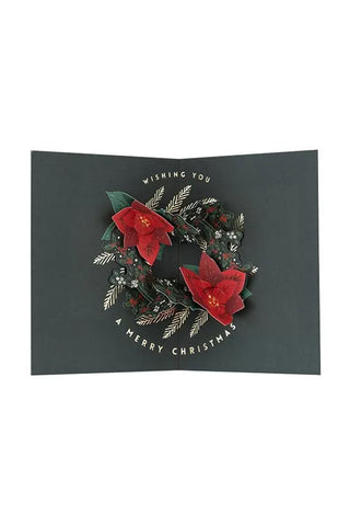 Green pop-up Christmas card open view with red poinsettia wreath and 'Merry Christmas'