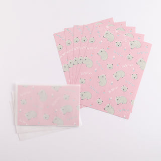 Pink wombat pattern letter sheets, multiple cards fanned out with uniform design