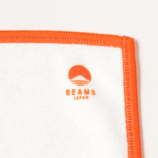 White cleaning cloth with orange binding and BEAMS JAPAN logo on corner.