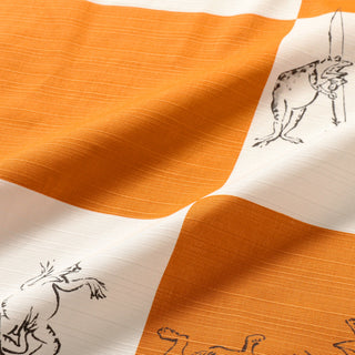 Orange and white furoshiki with textured weave and black line animal drawings