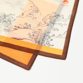 Corner close-up of orange and white handkerchief with gray animal sketches and brown trim.