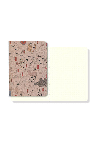 Pocket notebook opened to cream pages, pink illustrated back cover visible