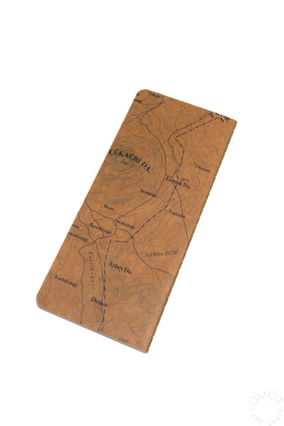 Topographical map notebook in brown with angled cover showing route lines