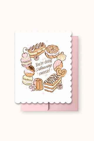 Die-cut greeting card with scalloped edges and cupcake illustration, 'You're doing amazing, Sweetie!'