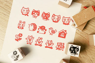 Rubber stamp set with red cat character designs and stacked stamp blocks